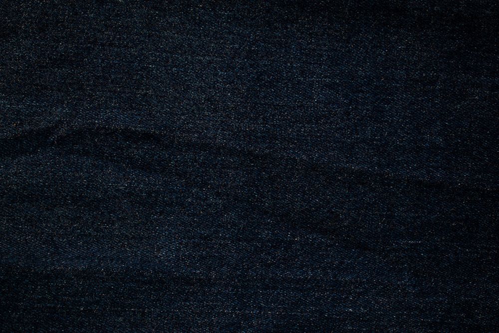 Flat view Dark blue or Navy jeans fabric texture background.