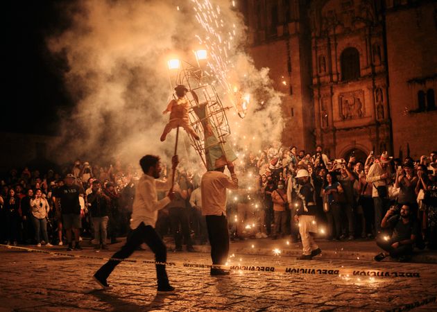 Two men holding up effigy’s and Catherine wheel firework