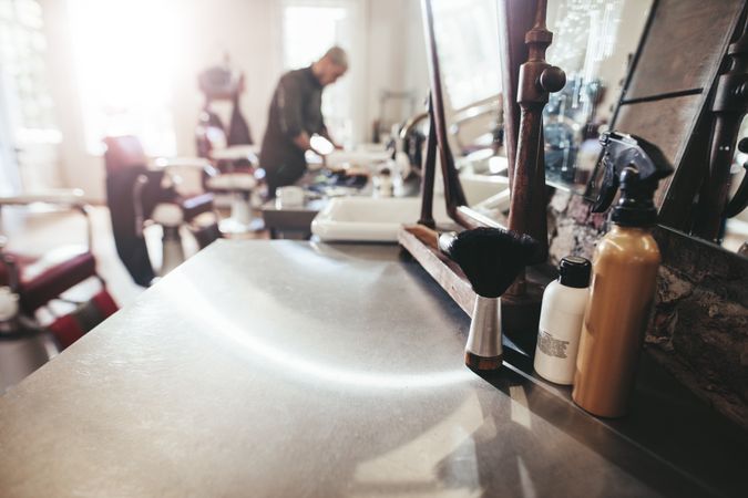 Barbershop tools on counter with barber in background
