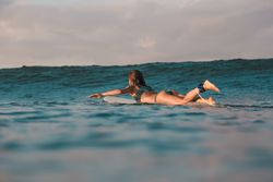 woman on surf board floating on water