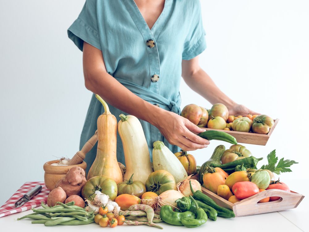 Woman with ripe fresh vegetables