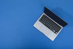 Looking down at blue room with laptop with blank screen