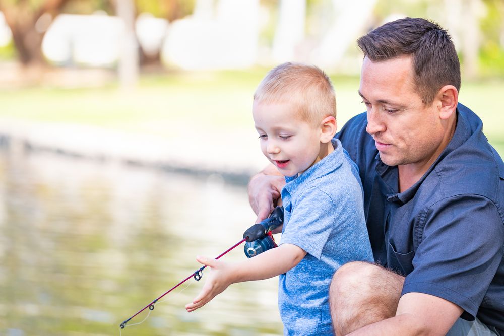 Father and Son Fishing Together At The Park