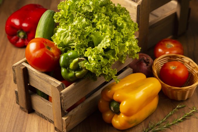 Box of fresh vegetables on wooden table