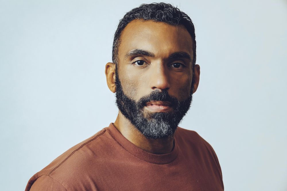 Head shot of intense Black male in grey studio