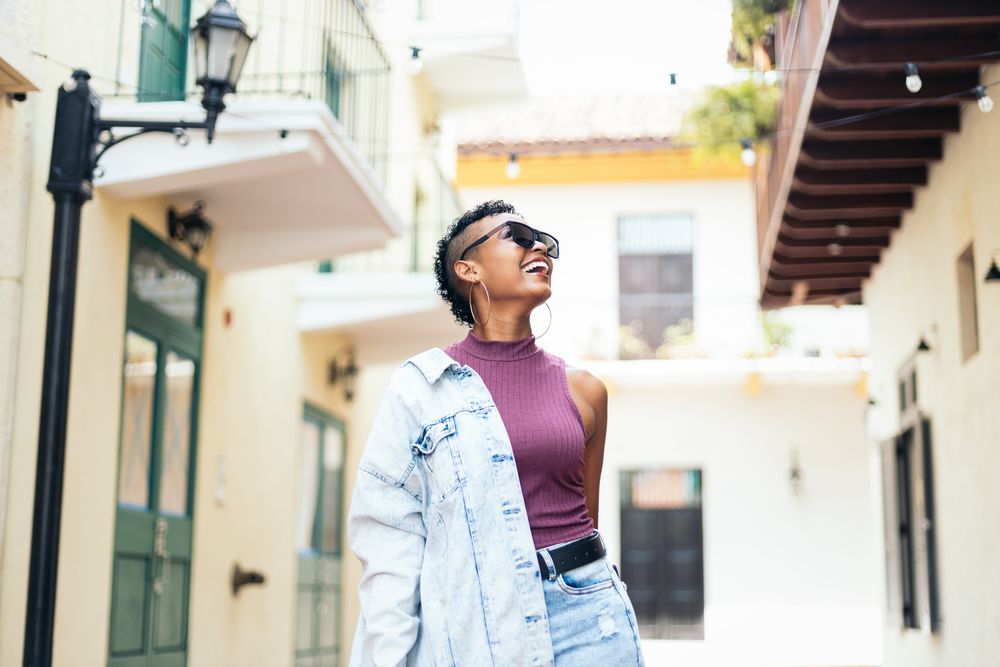 Portrait of a cool Latin American woman walking in the city