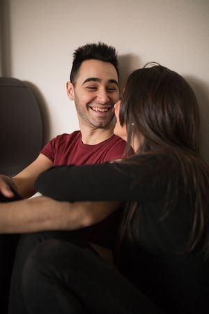 Couple sitting near fireplace on floor