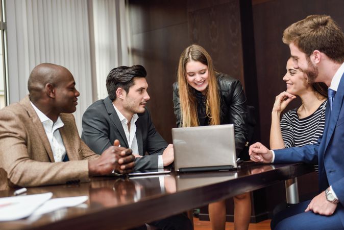 Female leading her colleagues in a brain storming meeting at work