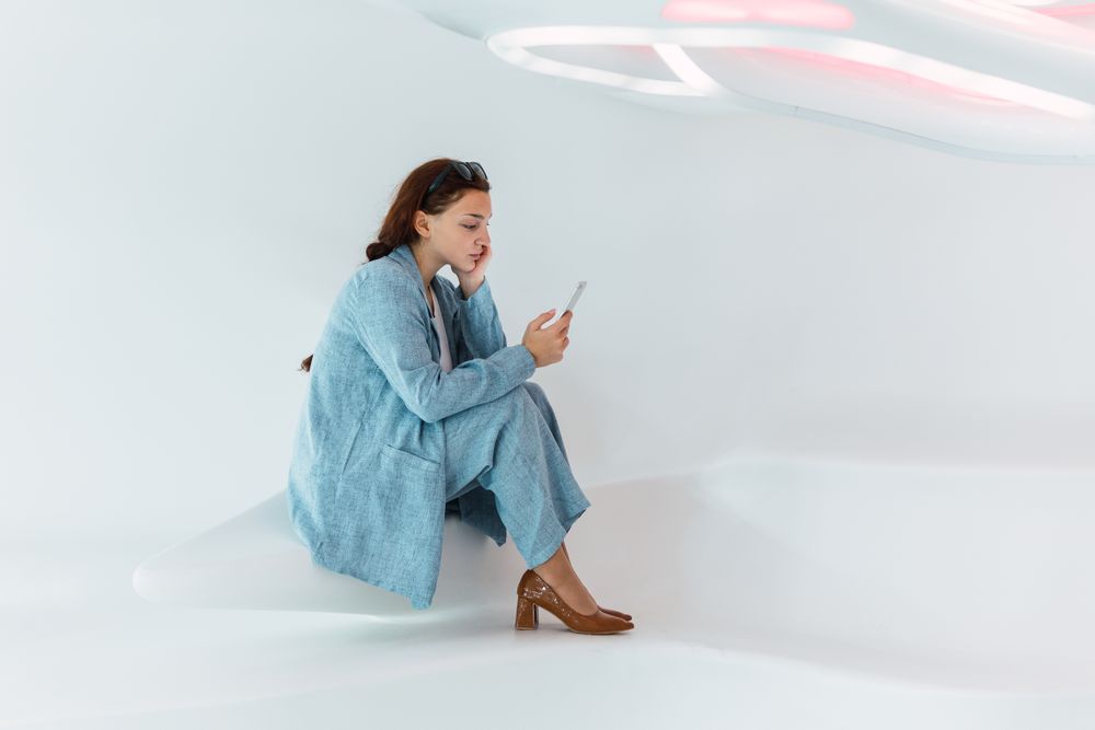 Woman browsing smartphone in studio