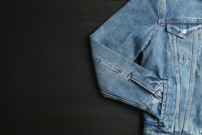 Denim jacket on background, space for text