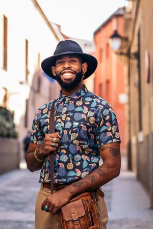 Stylish Black man walking on the city street