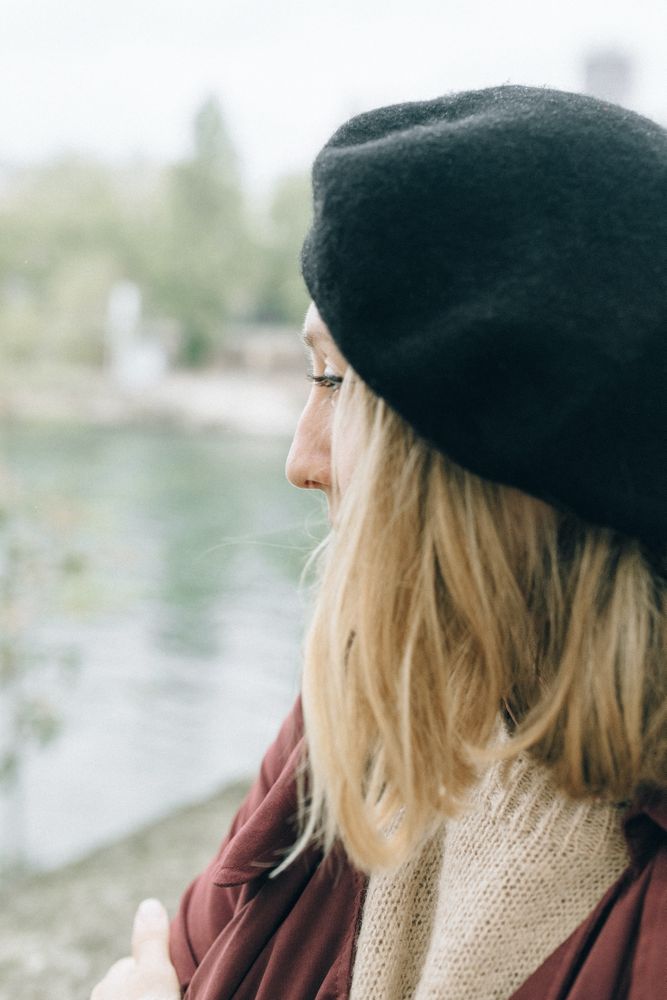 Side view of blonde woman wearing dark hat
