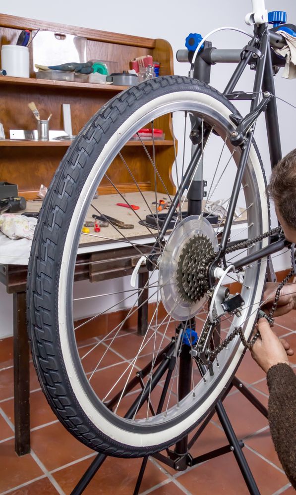 Real bicycle mechanic repairing custom fixie bike