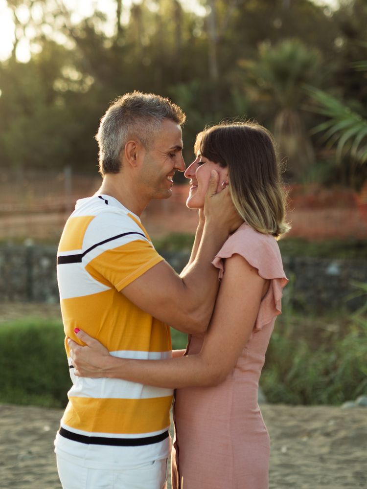 Happy couple looking at each other on beach
