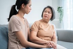 Asian mature mother comforting her daughter