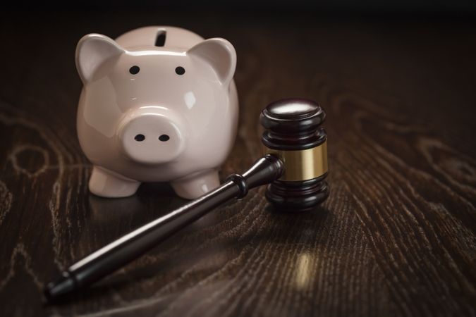 Gavel and Piggy Bank on Table