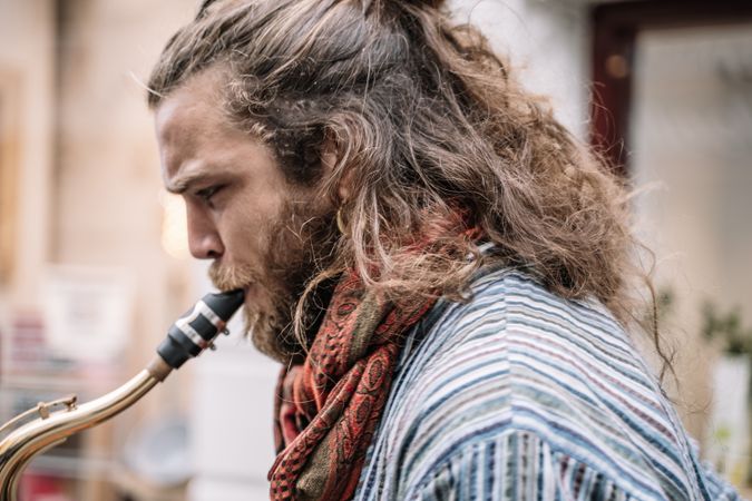 Male saxophonist plays Sax in the street