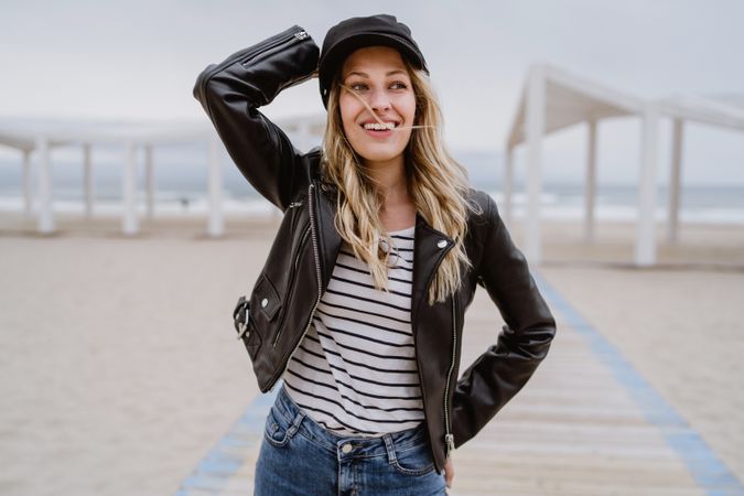 Woman on white wooden pier with ocean on background