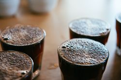 Close up shot of hot coffee in glasses lined up ready for coffee tasting