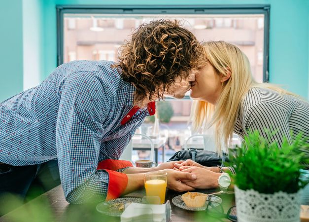 Couple kissing in a cafe