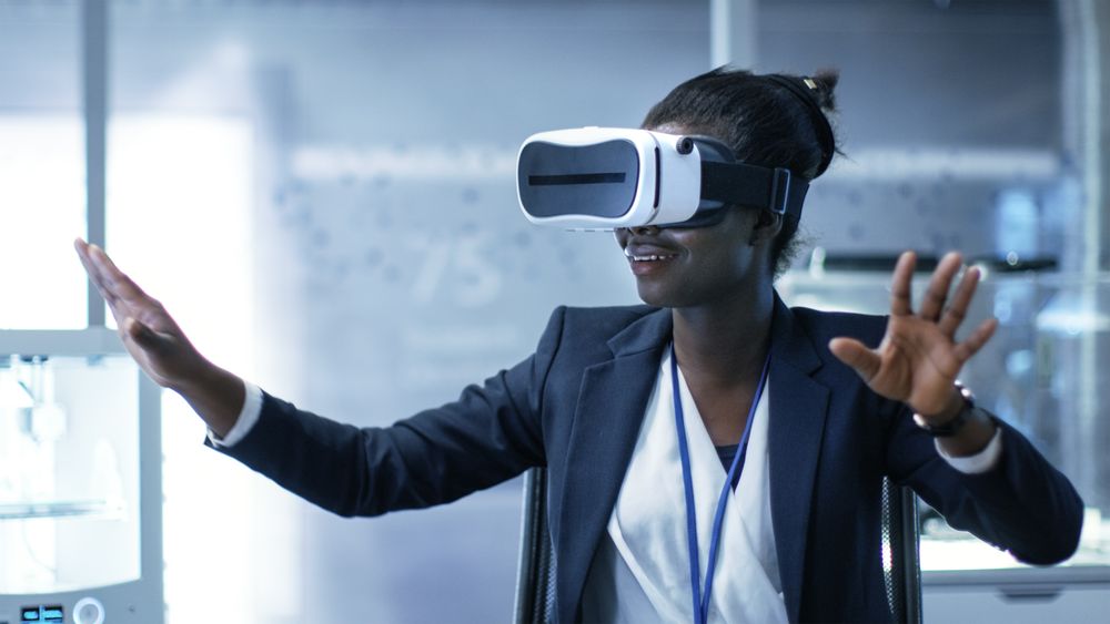 Young Black Female Virtual Reality Engineer/ Developer  Wearing VR Headset Creates Content.