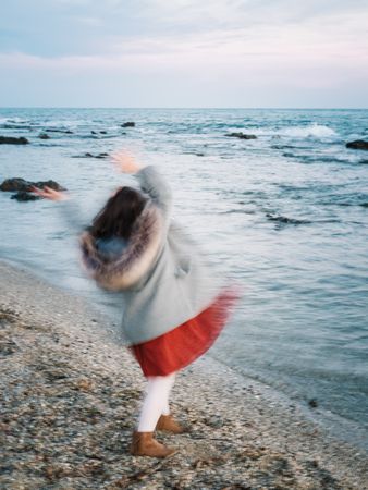 back view of little girl looking at sea