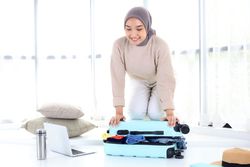 Woman Preparing Suitcase for Summer Vacation Travel Trip