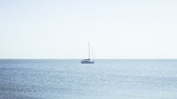 Boat between waves on water surface