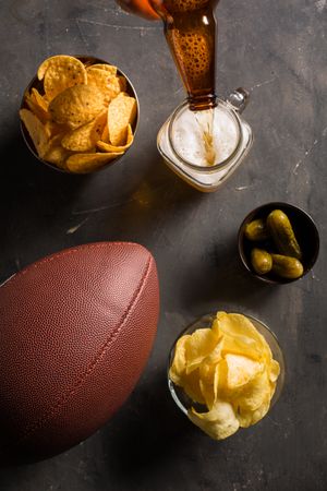 Snacks, beer and american football ball