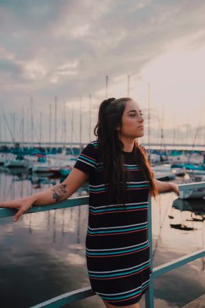 Smiling female walking standing on busy urban pier