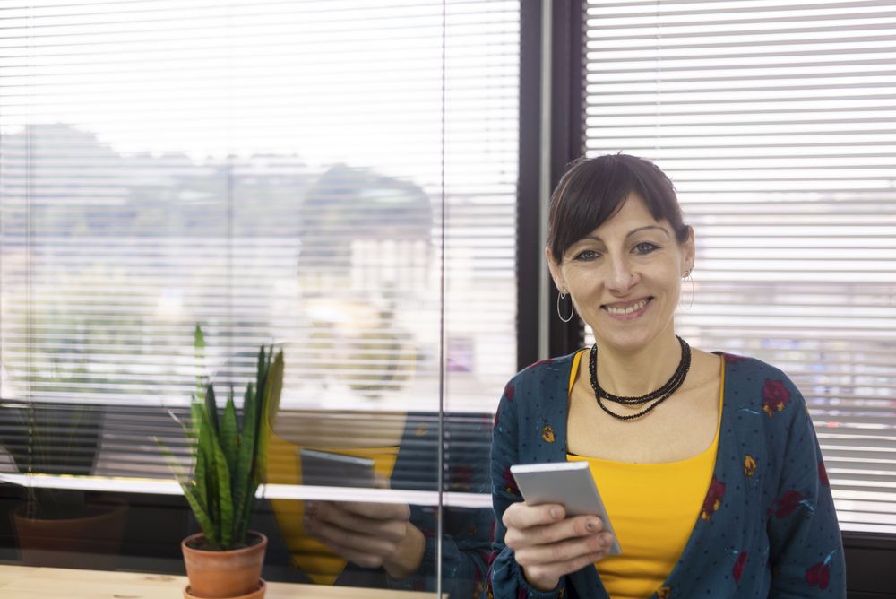 Businesswoman using smartphone at office