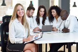 Blonde business leader smiling in office looking at camera