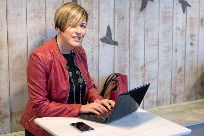 Woman checking laptop in cafe