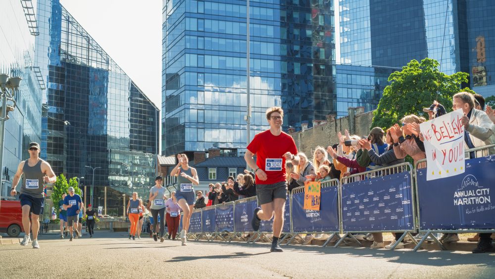 Diverse Group of People Competing in a Marathon Race in the City.