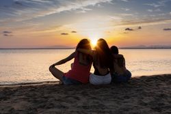 Peaceful fellows embracing on seashore