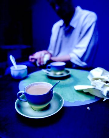 Man sitting at table with tea