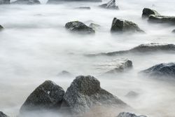 Ocean Mist Seascape of Water Rushing through Rocks
