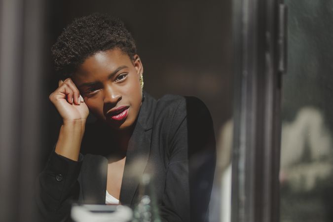 Smiling stylish Black woman in cafe