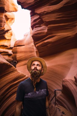 Bearded traveler looking at ravine walls