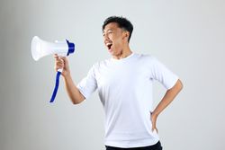 Asian Young Man in T shirt Shouting Using Megaphone