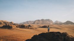 Anonymous woman standing in rocky terrain