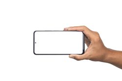 male hand holding smartphone horizontally with blank screen smartphone