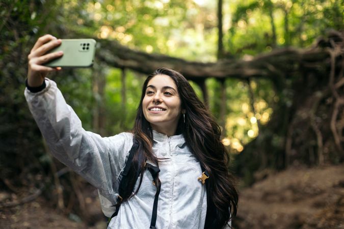 Woman taking selfies in the forest