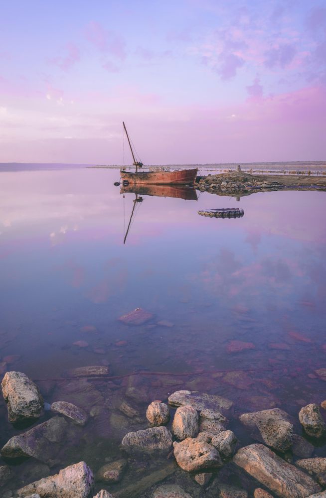 Brown boat on body of water