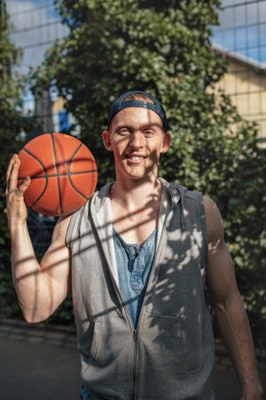 Handsome young basketball player with a ball