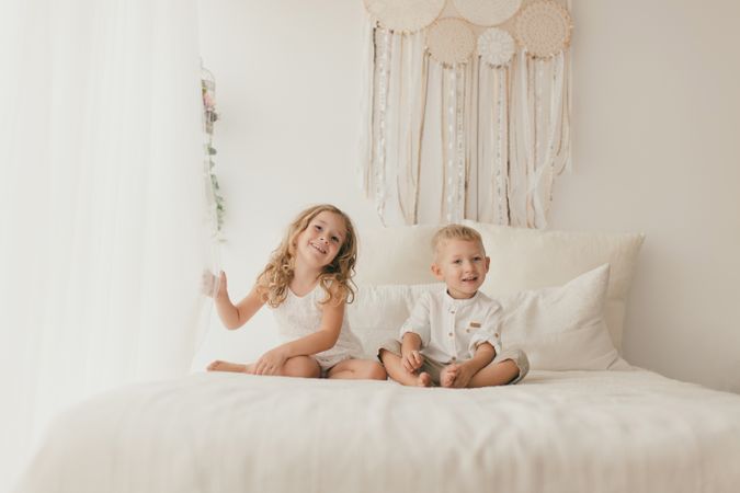 Sister embracing little brother at home