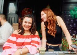 London, England, United Kingdom - August 27, 2022: Female friends smiling at street party in London 0VZAX0