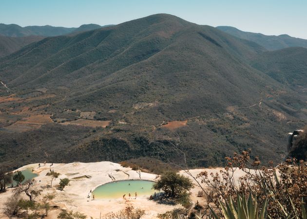 Looking down at people swimming in natural mountain springs