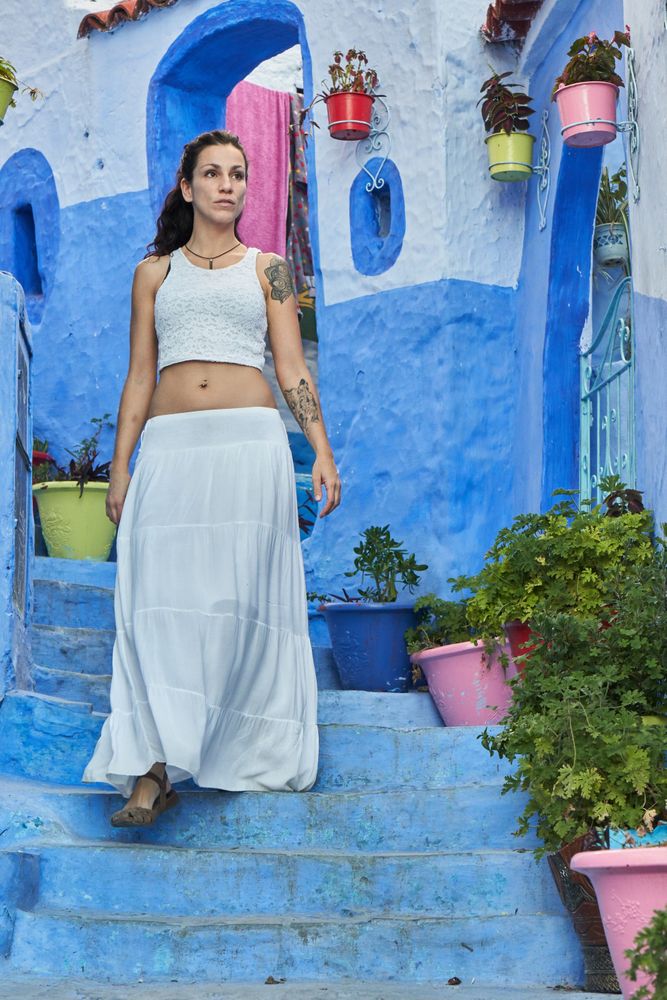 Woman on steps between ancient buildings