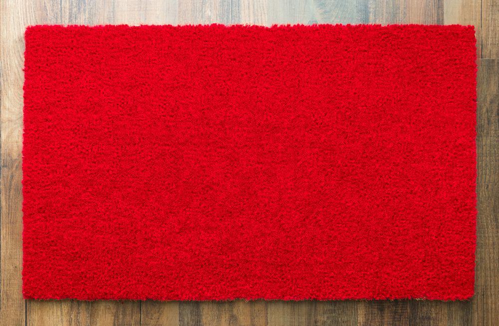 Blank Red Welcome Mat On Wood Floor Background Ready For Your Own Text